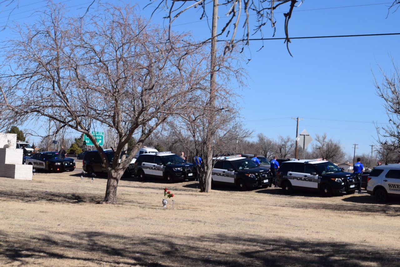 Police cars parked at the funeral service.