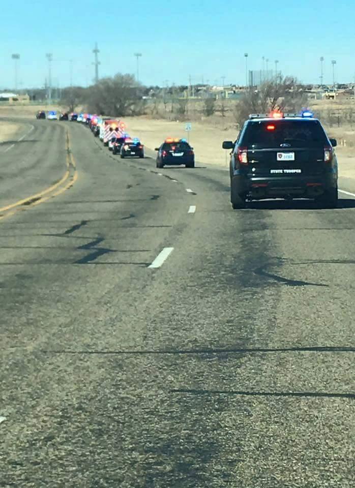 Line of cars driving to funeral.